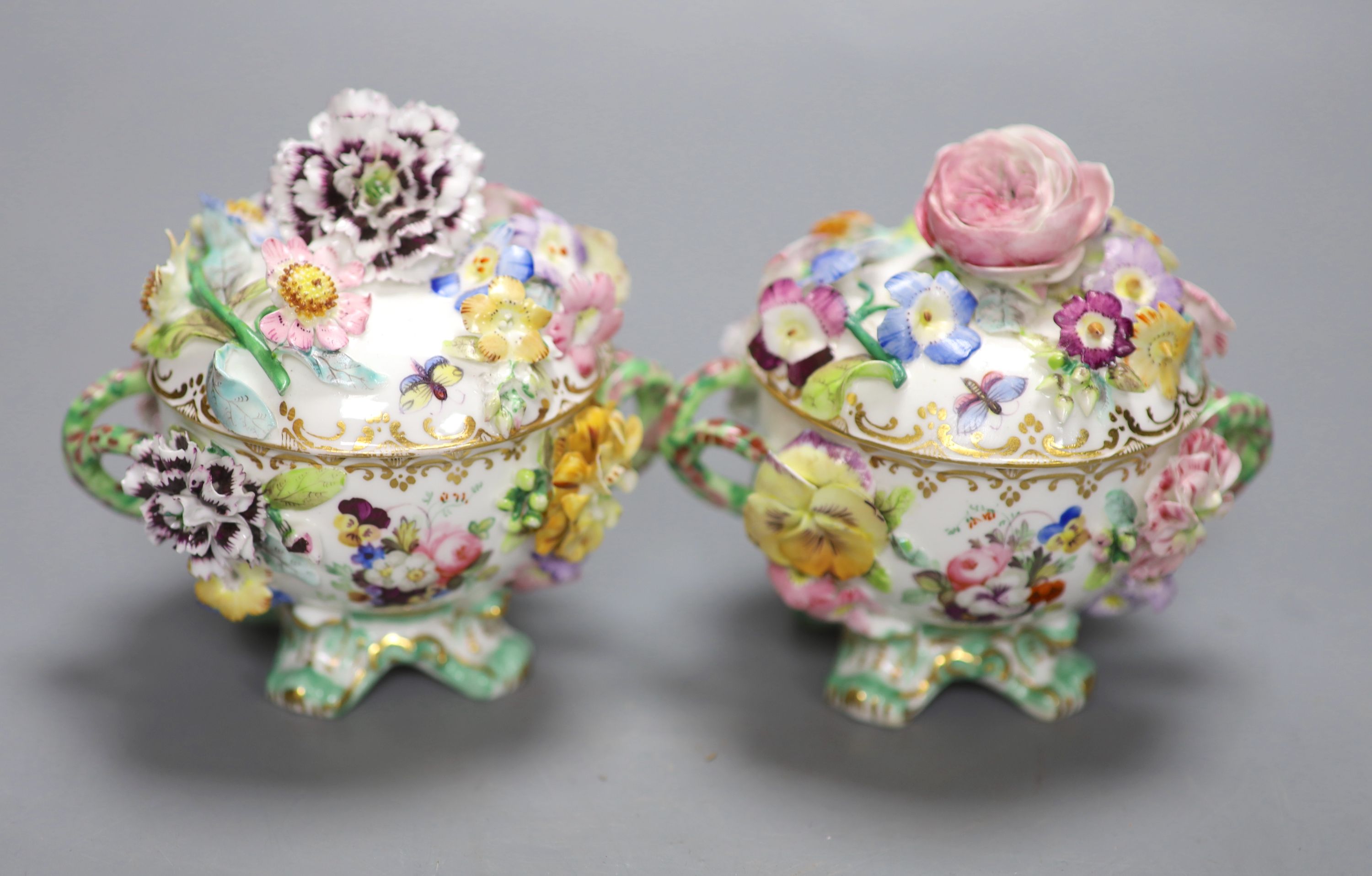 A mid 19th century Coalport pair of floral encrusted two handled cups and covers